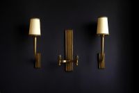 Jean PASCAUD (1903-1996)  Ensemble composé d'une applique double et d'une paire d'appliques simples en bronze doré patiné.