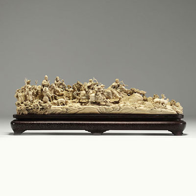 China - Ivory group carved in a tusk, depicting a hunt, silver-veined wooden base, circa 1920-30