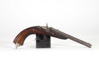 Pistolet de tir de type Flaubert, canon octogonal ciselé, crosse en noyer, XIXème, en coffret.