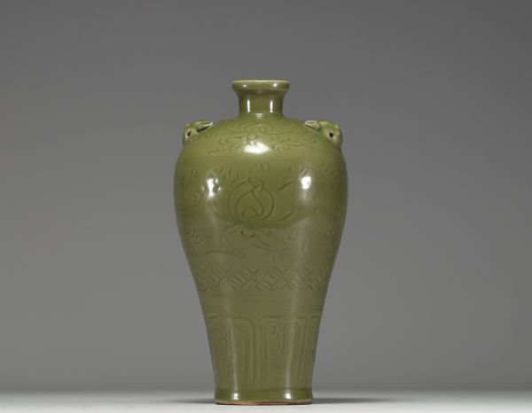 China - A green monochrome porcelain vase with floral decoration in relief, 19th century.