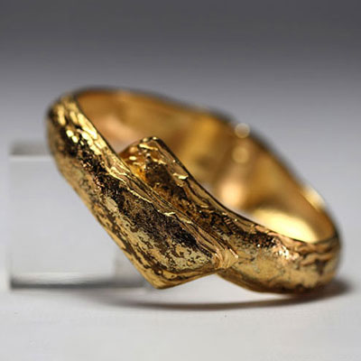 Yves SAINT LAURENT - Gilt metal bracelet, signed.