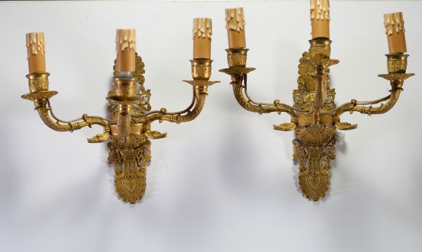A pair of Empire ormolu sconces with three light points.