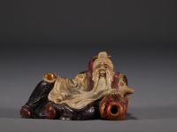 China - Polychrome stone sculpture of a Dignitary on a wooden base.