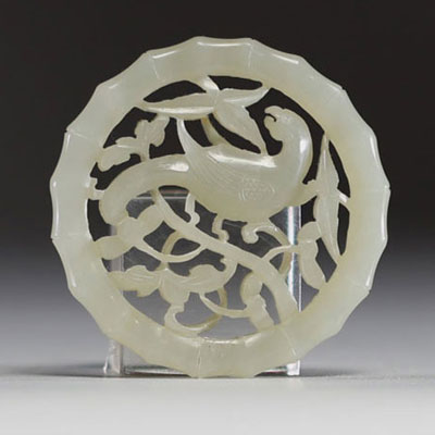 China - Carved jade disc pendant with a magpie on a plum blossom, 18th century.