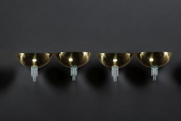 Set of four brass and green glass wall lights in the style of Jean Perzel.