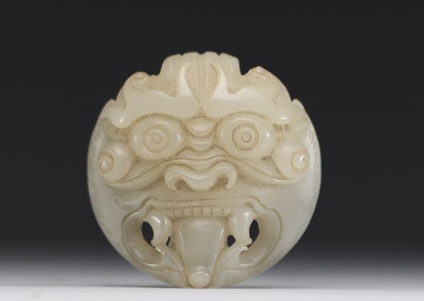 China - Taotie mask in carved green jade.