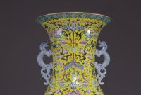 China - Imposing pink family polychrome porcelain vase with floral decoration on a yellow background, handles depicting dragons, 20th century.