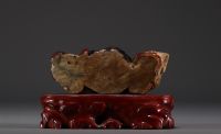 China - Polychrome stone sculpture of a Dignitary on a wooden base.