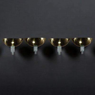 Set of four brass and green glass wall lights in the style of Jean Perzel.