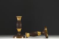A pair of small gilt bronze candlesticks with a brown patina, from the Restoration period.