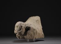 Piece of stone carved in the shape of a figure, on a base.