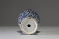 China - A white-blue porcelain vase decorated with flowers and foliage, chilong in relief on the shoulder, 19th century.