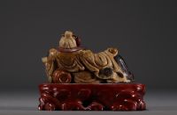 China - Polychrome stone sculpture of a Dignitary on a wooden base.