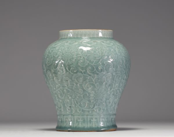 China - Pale green monochrome porcelain vase with floral decoration in relief, blue mark under the piece, 17th century.