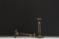 A pair of gilt bronze and brown patina candlesticks, decorated with acanthus leaves, from the Restoration period.