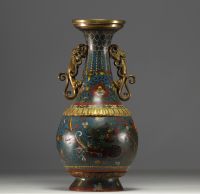 China - A Qing-period cloisonné vase with dragon decoration and bronze handles.