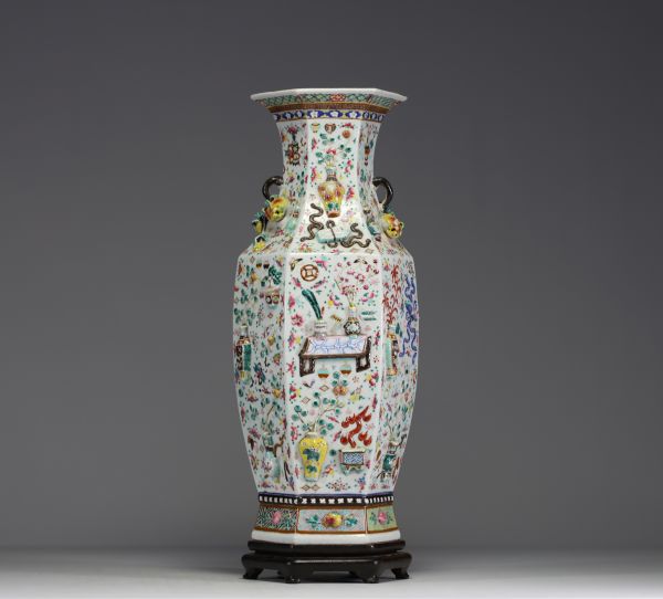 China - A rare pink family polychrome porcelain vase with relief decoration of domestic objects, fruit and floral motifs, hexagonal base, 19th century.