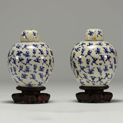 China - Pair of white-blue porcelain covered pots with children, wooden base.