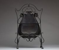 Par-feu Art Nouveau, monture en fer forgé patiné noir aux motifs de volutes, grand décor central en cuivre repoussé fixé par fils de fer.