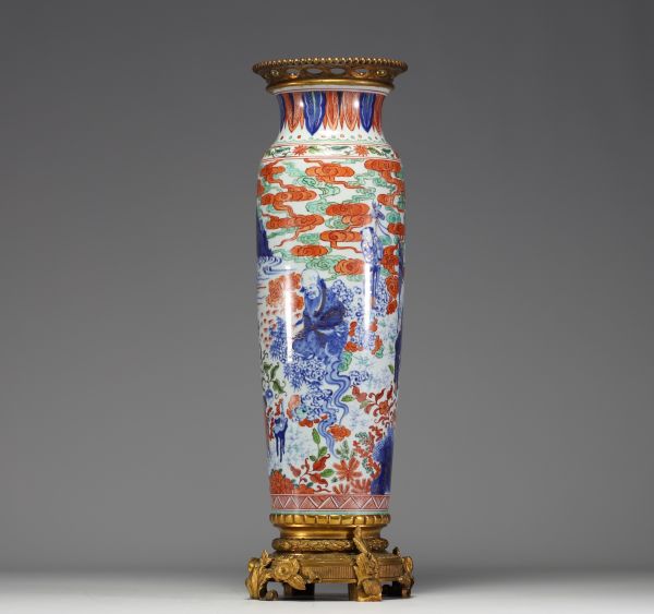 China - A polychrome porcelain vase with cloudy landscape and figures on a bronze frame, Transition period, 17th century.