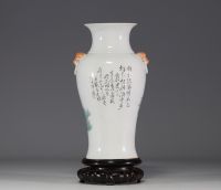 China - Famille rose porcelain vase decorated with traditional furniture and a poem.