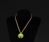Yves SAINT LAURENT - Pendentif en porcelaine de couleur verte et or, monogrammé YSL.