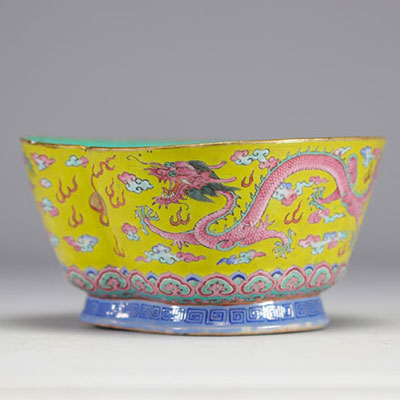 A Famille Rose porcelain bowl decorated with imperial red dragons on a yellow ground with the mark and of the Tao Kuang period (1821-1850)