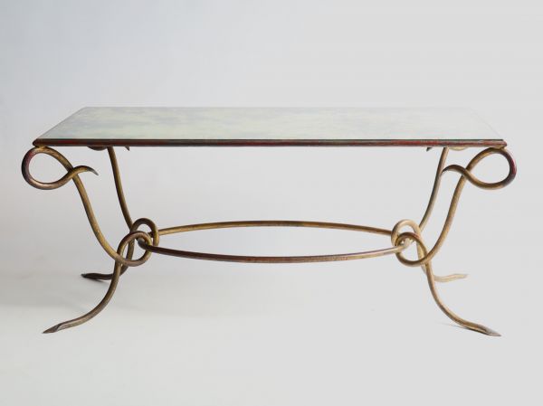 René DROUET (1899-1993) Gilded wrought iron coffee table with eglomised glass top, circa 1940