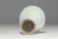 China - An 18th century celadon porcelain vase decorated with flowers in relief.