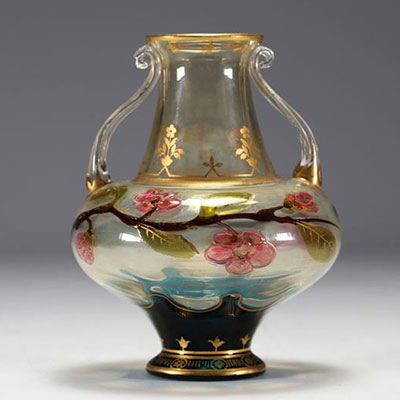 An Art Nouveau vase in glass with gold flower motifs