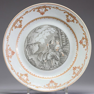 Chine – Assiette en porcelaine de la Compagnie des Indes à décor peint en grisaille d’une scène érotique, XVIIIe siècle  Assiette en porcelaine décorée en grisaille et rehauts orangés, ornée au centre