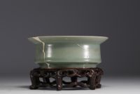 China - Celadon porcelain bowl on carved wooden base, Song dynasty.