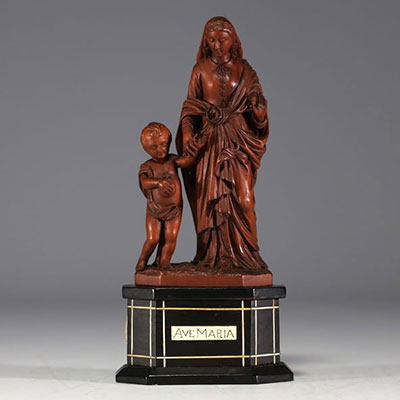 Boxwood Madonna and Child on a blackened wooden base, bone 