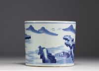 China - A white and blue porcelain brush with landscape decoration.
