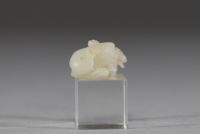 Chine - Sculpture en jade blanc représentant un chien chinois, fin de la dynastie Qing Sculpture délicatement taillée dans un jade blanc de belle qualité, figurant un chien chinois couché, le corps ramassé et la tête tournée vers l’avant. Le jade présente une teinte douce et homogène, typique des œuvres réalisées à la fin de la dynastie Qing. Le sujet animalier, fréquent dans l’art chinois, symbol