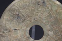 China - Bi jade disc with finely carved archaic motifs.