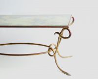 René DROUET (1899-1993) Gilded wrought iron coffee table with eglomised glass top, circa 1940