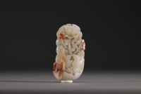 China - White and brown jade pendant with lotus flower and duck design.