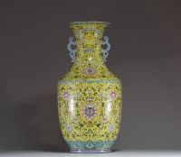 China - Imposing pink family polychrome porcelain vase with floral decoration on a yellow background, handles depicting dragons, 20th century.