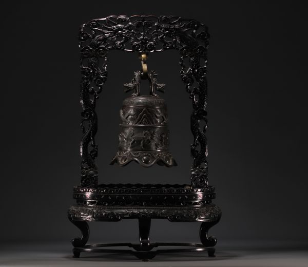 Chine - Cloche en bronze surmontée d'un dragon, supportée par un socle en bois sculpté, vers 1900.