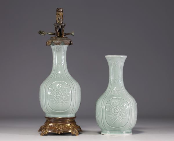 China - A celadon porcelain oil lamp and shaft decorated with flowers and bamboos, 18th-19th century.