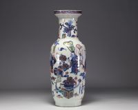 China - Large polychrome porcelain vase richly decorated with figures and furniture, 19th century.