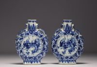 China - Pair of blue-white gourd vases decorated with figures at play, chimera handles, 19th century.