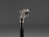 Art Deco silver cane with lioness head decoration and glass eyes.