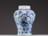China - A white-blue porcelain baluster vase decorated with flowers, mugwort leaf mark within a double circle, Kangxi.