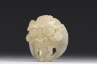 China - Taotie mask in carved green jade.