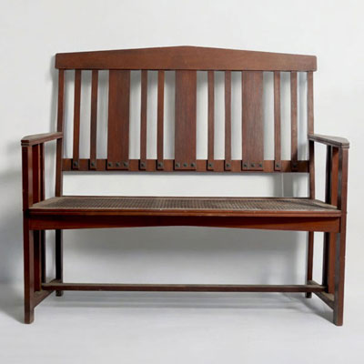 Gustave SERRURIER-BOVY (1858-1910) ‘Bach’ series two-seater bench in padouk, cane seat, brass screws, circa 1906.