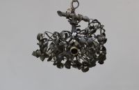 A three-light bronze chandelier with a green patina and opaline glass, representing a mistletoe ball, circa 1900.