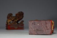 China - Pair of gilded and polychromed carved stone Fô dogs, 18th century.
