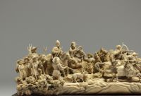 China - Ivory group carved in a tusk, depicting a hunt, silver-veined wooden base, circa 1920-30